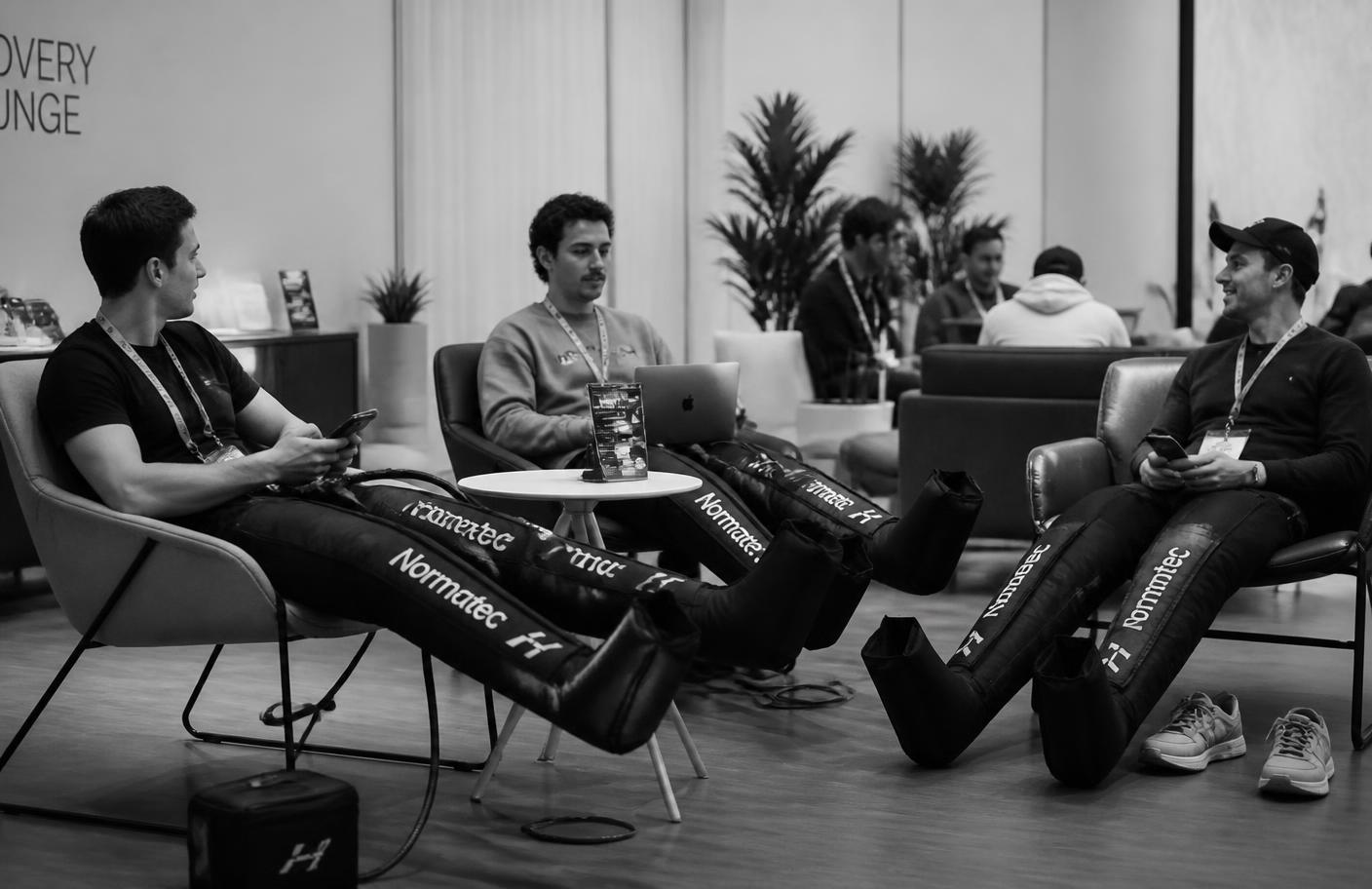 Conference attendees using recovery equipment in a lounge